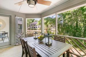a dining room with a table and chairs on a porch at 5537 Green Dolphin Way in Kiawah Island