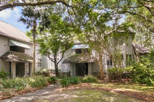 a white house with trees and a driveway at 5537 Green Dolphin Way in Kiawah Island