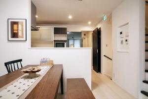 a kitchen and dining room with a wooden table at Tokyo stay 365 in Tokyo