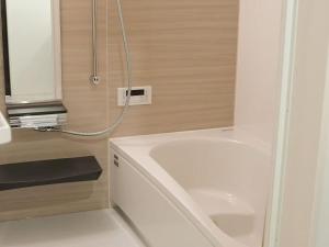 a bathroom with a white tub and a sink at Tokyo stay 365 in Tokyo +16 photos
