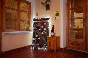 a room with a santa hat sitting on a dresser next to a door at Borbála Vendégház in Füzér