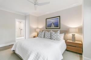 a white bedroom with a white bed and a window at 4910 Green Dolphin in Kiawah Island
