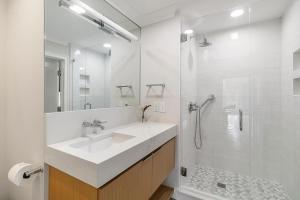 a white bathroom with a sink and a shower at 4910 Green Dolphin in Kiawah Island +28 photos