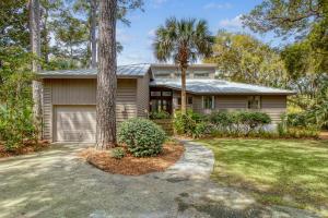 a house with a palm tree in front of it at 273 Summer Tanager in Kiawah Island