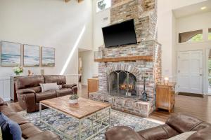 a living room with a brick fireplace with a tv at 273 Summer Tanager in Kiawah Island