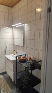 a bathroom with a sink and a counter with a mirror at Mumrila in Pori