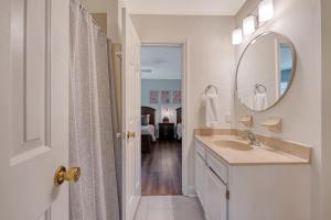 a white bathroom with a sink and a mirror at 273 Summer Tanager in Kiawah Island +37 photos