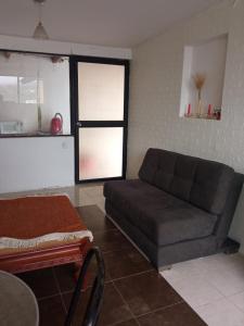 a living room with a couch and a table at SUITE CUMBAYA Junto Reservorio in Quito