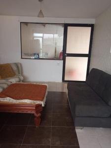 a living room with a couch and a couch and a window at SUITE CUMBAYA Junto Reservorio in Quito +8 photos