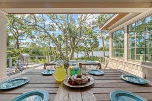 a wooden table with a plate of food on a porch at 68 New Settlement in Kiawah Island