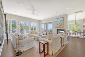 a living room with white furniture and a fireplace at 338 Surfsong in Kiawah Island