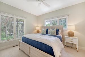 a bedroom with a bed and two windows at 338 Surfsong in Kiawah Island +101 photos