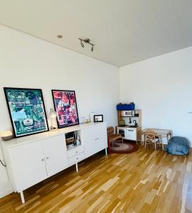 a living room with white walls and a wooden floor at Entire Home in Billund Center in Billund