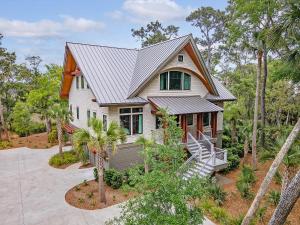 a white house with a metal roof at 135 Halona Ln in Kiawah Island