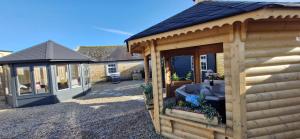a log cabin with a gazebo at Yellow Stone Farm Lodge and Spa in Clonbrown