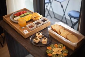 a table with a tray of different types of food at Silver Stone Studio Apartments in Gjirokastër +16 photos