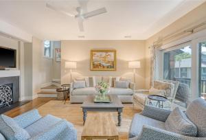 a living room with a couch and a fireplace at 4925 Green Dolphin in Kiawah Island