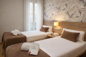 a hotel room with two beds with towels on them at Sagrada Familia Xamfrà in Barcelona +144 photos