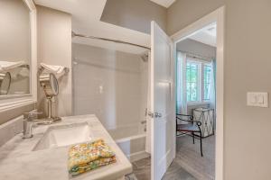 a white bathroom with a sink and a mirror at 4925 Green Dolphin in Kiawah Island +33 photos
