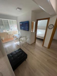 a living room with a table and a mirror at Piso en Calle Albares De La Ribera in Madrid