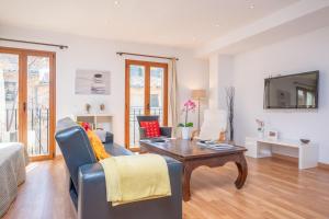 a living room with a couch and a table at Residencial Suites Valldemossa - Turismo de Interior in Valldemossa