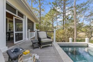 a patio with a chair next to a swimming pool at 711 Glossy Ibis in Kiawah Island