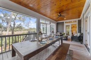 a dining room with a table on a balcony at 711 Glossy Ibis in Kiawah Island