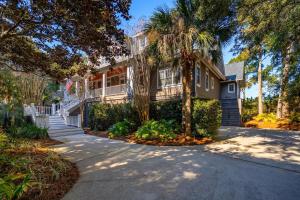 a house with palm trees and a driveway at 711 Glossy Ibis in Kiawah Island