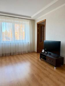 an empty living room with a flat screen tv at Center two bedroom apartment in Daugavpils
