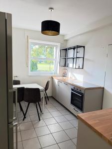 a kitchen with a table and a window and a table at Monteurswohnung Emsdetten in Emsdetten