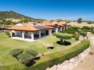 an aerial view of a house with a stone wall at Sole d'Estate Agriresidence in Costa Rei