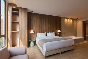 a bedroom with a large bed and a couch at Hotel Lincoln in Medellín +75 photos