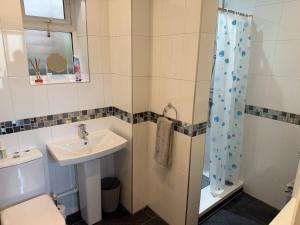a bathroom with a sink and a toilet and a shower at The Escape in Wirksworth