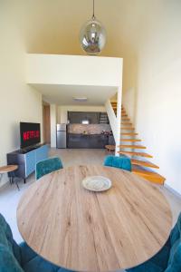 a dining room with a wooden table and blue chairs at Santo Evdokia in Vóthon