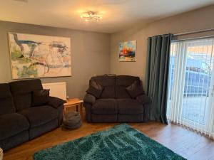 a living room with a couch and a chair at The Escape in Wirksworth