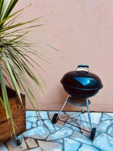 a black grill sitting next to a wall at Grande maison de ville MALO LEONE 250m2 pour 15 personnes proche du Puy du Fou in Mauléon