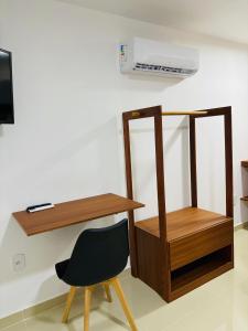 a desk and a chair in a room at oceanic suítes in Araruama