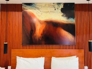 a painting above a bed in a hotel room at Mpala Boutique Hotel in Bulawayo +21 photos