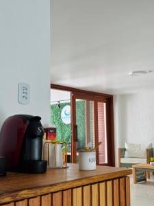 a kitchen with a counter top with a appliance at oceanic suítes in Araruama