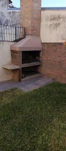 a bench sitting next to a brick building at Departamento duplex in Concordia