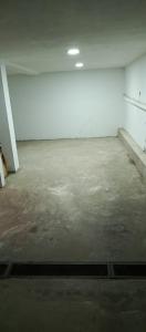 an empty room with a concrete floor and white walls at Departamento duplex in Concordia +1 photo