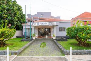 a house with a driveway in front of it at Vila Joya Boutique Hotel STP in São Tomé +54 photos