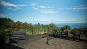 two chairs and a couch on a wooden deck at Igeldo in Orio
