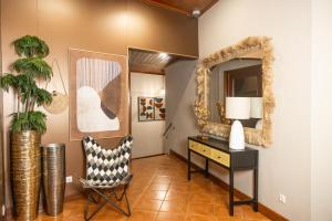 a room with a desk and a mirror and a chair at Vila Joya Boutique Hotel STP in São Tomé