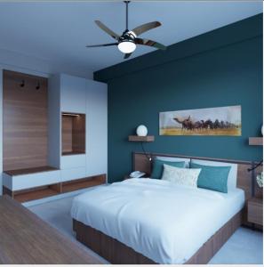 a bedroom with a large bed with a ceiling fan at Luxora Hotel Lodwar in Lodwar