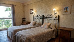 a hotel room with two beds and a window at Igeldo in Orio
