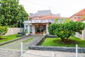 a building with a tree in front of it at Vila Joya Boutique Hotel STP in São Tomé
