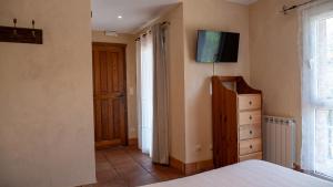 a bedroom with a bed and a television on the wall at Igeldo in Orio