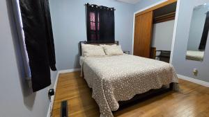 a small bedroom with a bed and a window at Gano Street Retreat in Great Bend