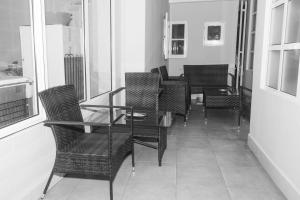 a dining room with a glass table and chairs at Vila Joya Boutique Hotel STP in São Tomé